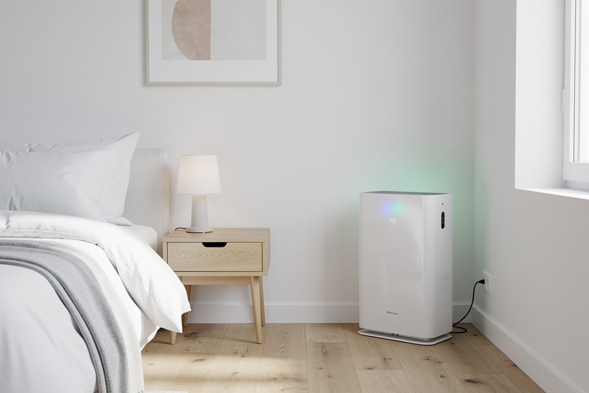 Air purifier running in a tidy bedroom