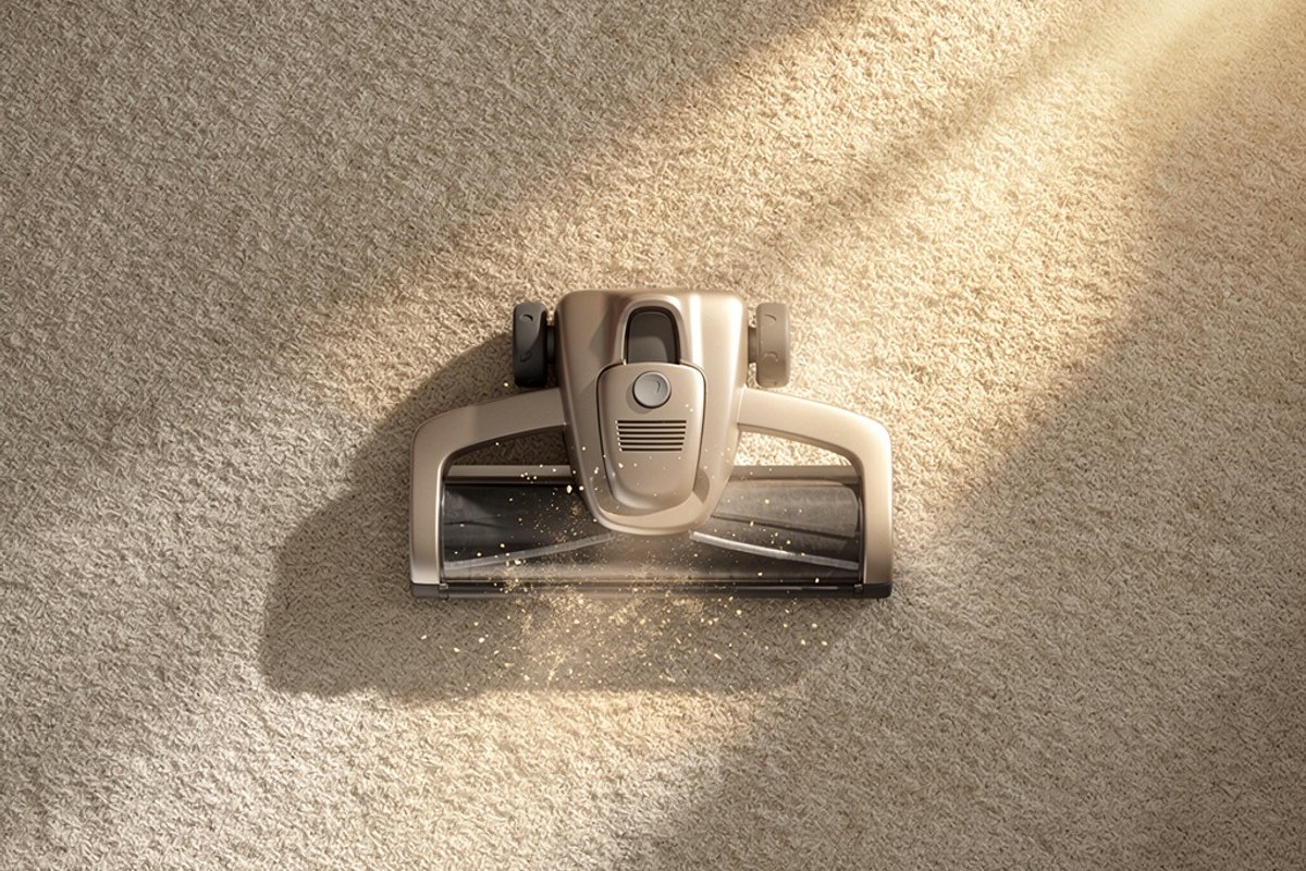 Vacuum cleaner on light carpet with dust particles in sunlight