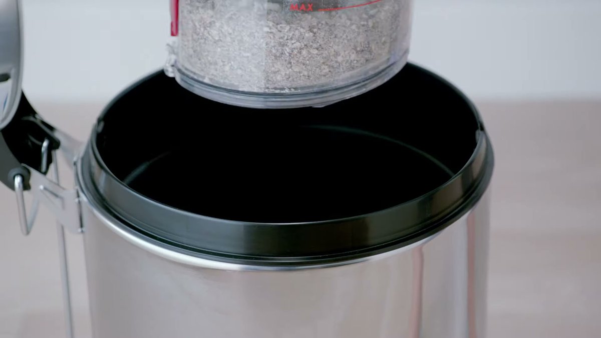 Dyson Big Ball Multi Floor Canister dustbin being emptied into canister