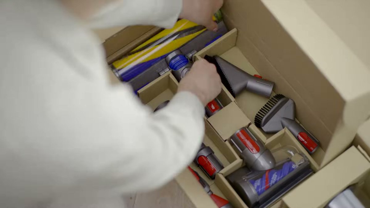 Dyson Gen5detect accessories being organized in a box with various attachments visible