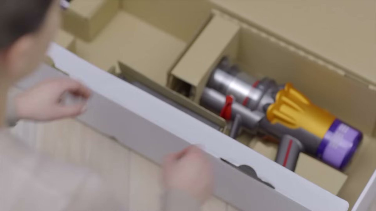 Dyson V12 Detect Slim being unboxed on hardwood floor
