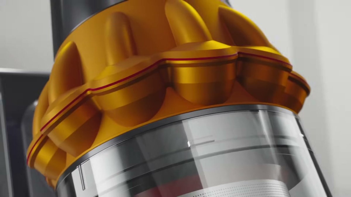 Close-up of the Dyson V15 Detect Absolute's transparent dustbin and gold cyclone assembly