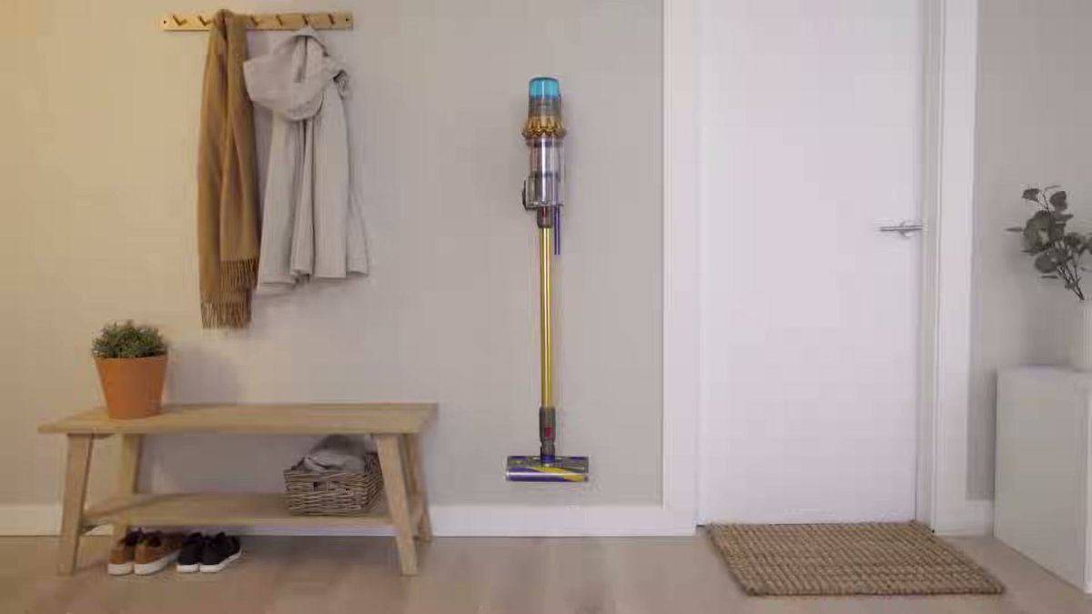 Dyson V15 Detect Cordless Vacuum standing upright in a modern entryway on hardwood floor