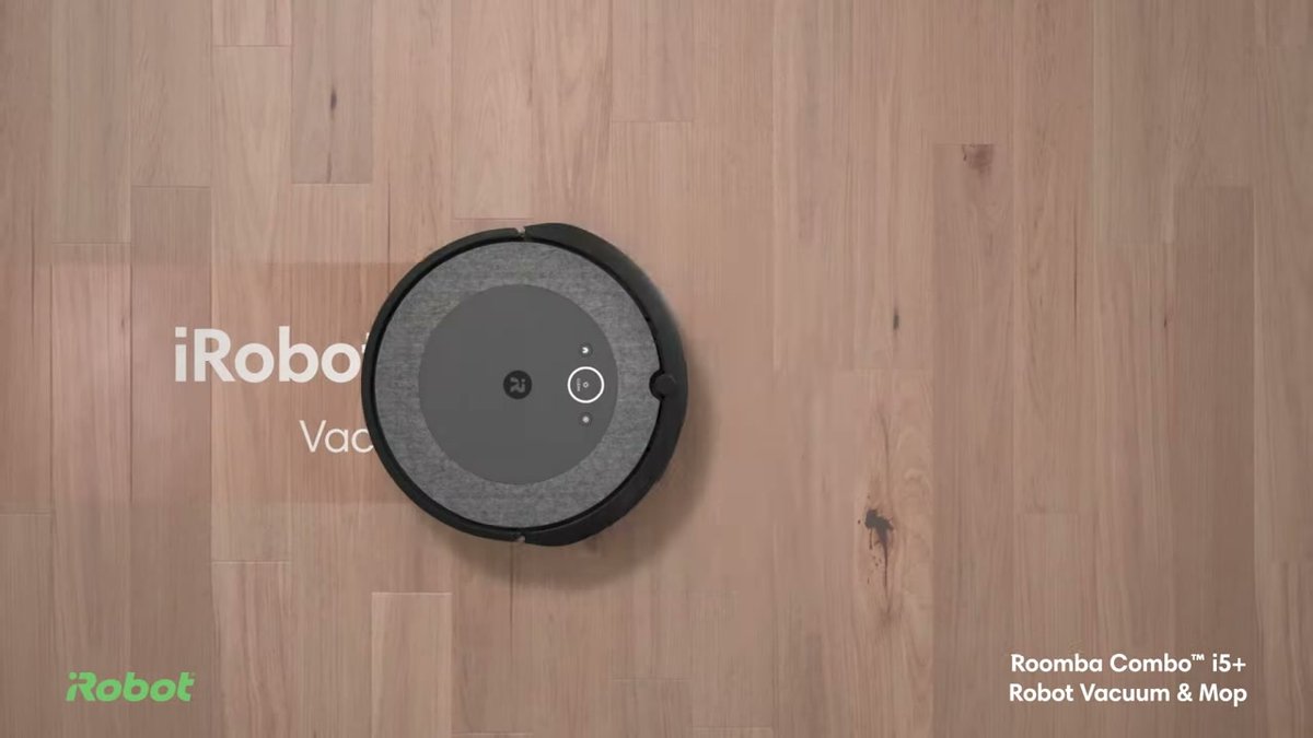 iRobot Roomba i5+ robot vacuum on hardwood floor, top view